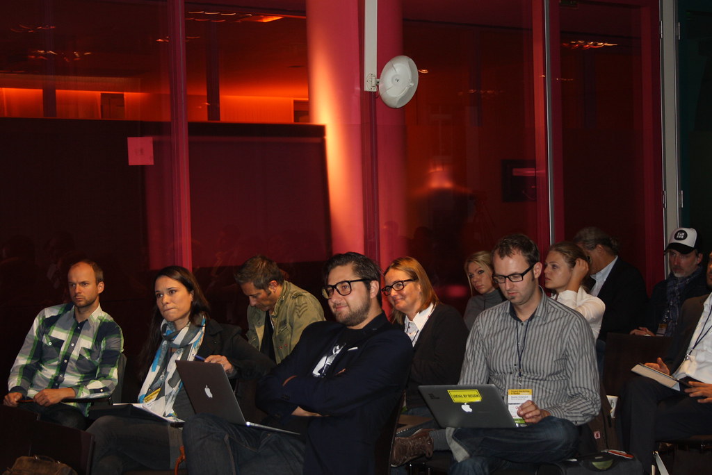 Audience with laptops at a marketing talk